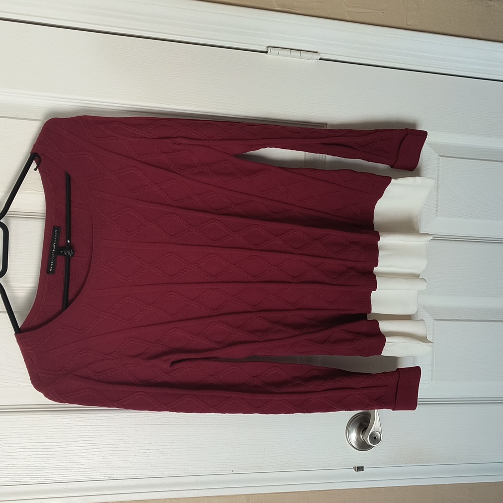 A pullover long sleeve sweater.